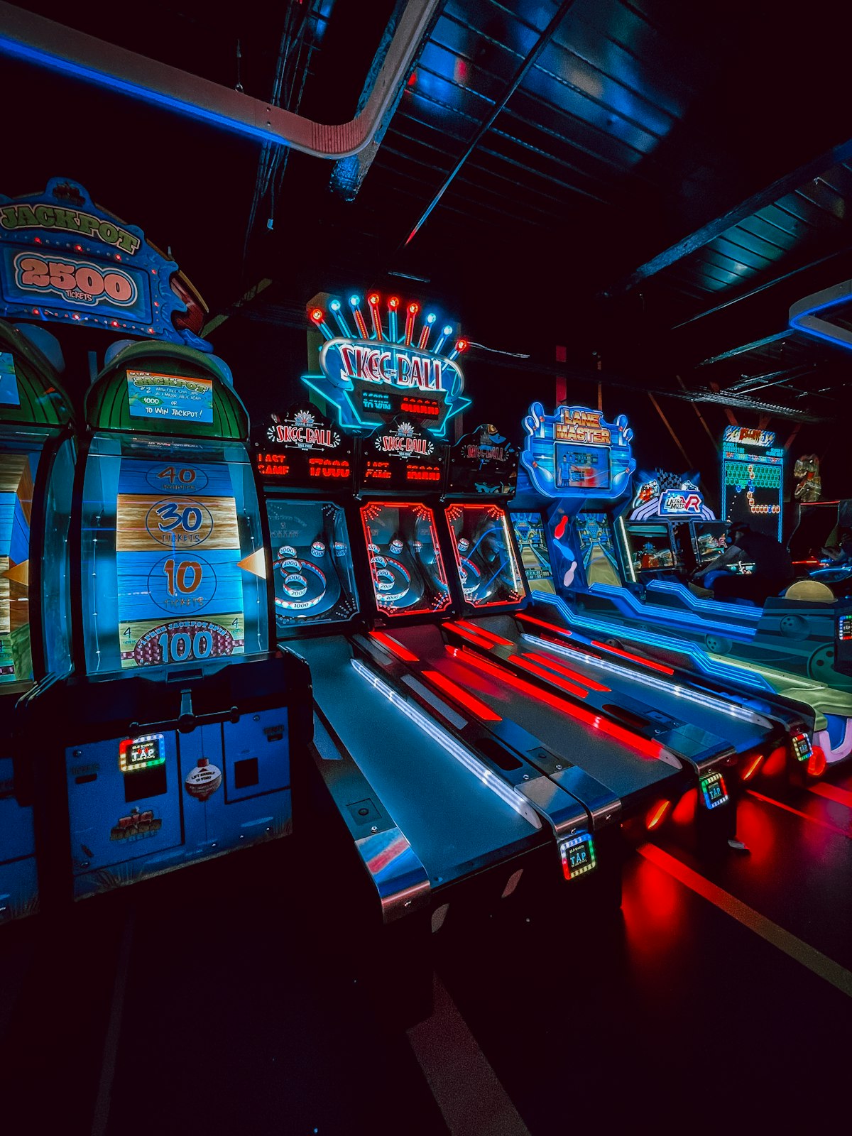Row of arcade machines in a dark room